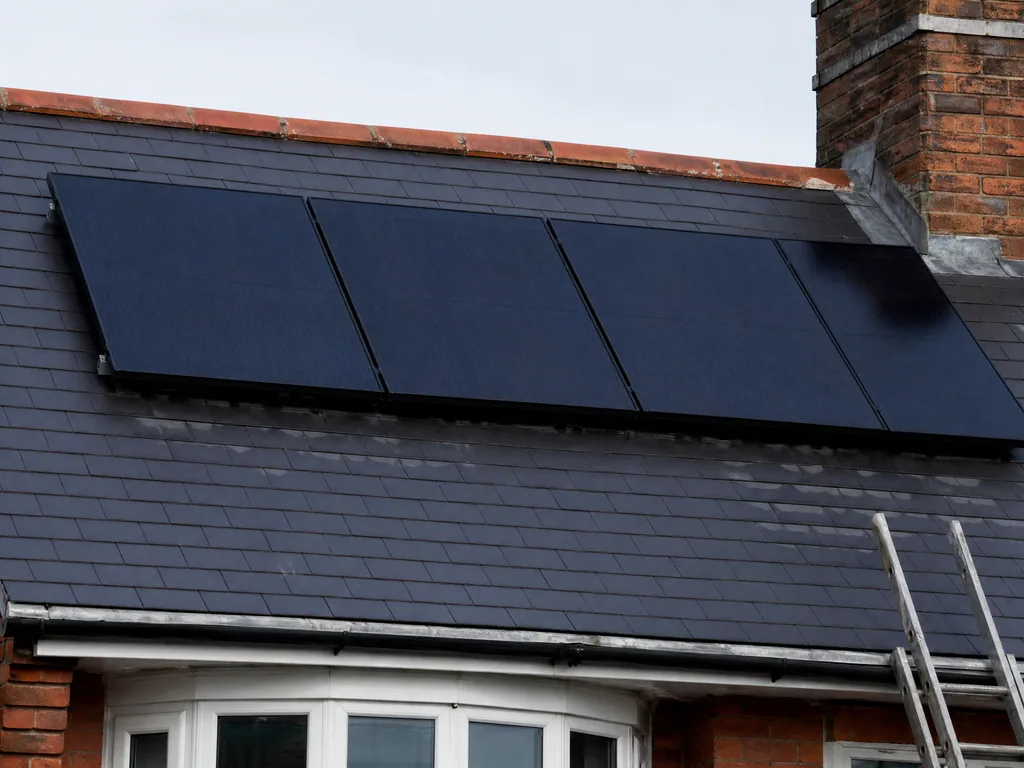 Clean solar panels on a slate roof after a service, Derby
