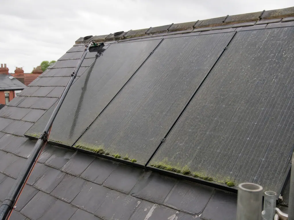 Solar panels with grime and moss on a slate roof, Derby