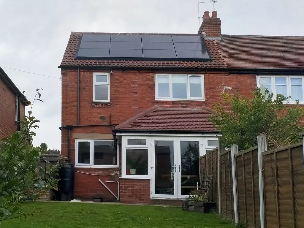 Solar panels on the rear roof of a semi, seen from the back garden, Derby